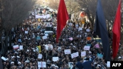 Iranian pro-government supporters march during the funeral of a young member of the Revolutionary Guards, Sajjad Shahsanai, in the city of Najafabad, Jan. 3, 2018. At least three other towns near the cultural hub of Isfahan also saw violence overnight, causing the deaths of a young member of the Revolutionary Guards, a policeman and a bystander. 