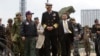 FILE - U.S. Adm. Samuel Locklear talks with Japanese Gen. Shigeru Iwasaki, front left, after inspecting Patriot missile units deployed in Tokyo, April 11, 2012.