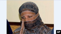FILE - In this Nov. 20, 2010 photo, Asia Bibi, a Pakistani Christian woman, listens to officials at a prison in Sheikhupura near Lahore, Pakistan. 