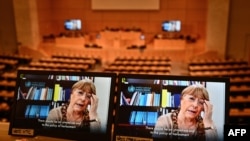 FILE - United Nations High Commissioner for Human Rights Michelle Bachelet is seen on a screen as she speaks via video-link during a session of the U.N. Human Rights Council, in Geneva, Feb. 25, 2021.