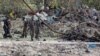 Somali soldiers attend the scene where a suicide car bomber detonated near the gates of the motor vehicle imports duty authority headquarters near the port in Mogadishu, Somalia, July 4, 2020. 
