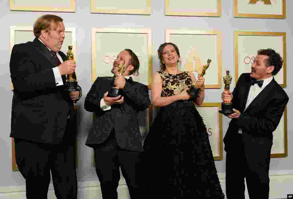 Phillip Bladh, from left, Carlos Cortes, Michellee Couttolenc and Jaime Baksht, winners of the award for best sound for "Sound of Metal," pose in the press room at the Oscars on Sunday, April 25, 2021, at Union Station in Los Angeles. (AP Photo…