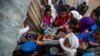 FILE - Displaced Tigrayans line up to receive food donated by local residents at a reception center for the internally displaced in Mekele, in the Tigray region of northern Ethiopia, May 9, 2021.