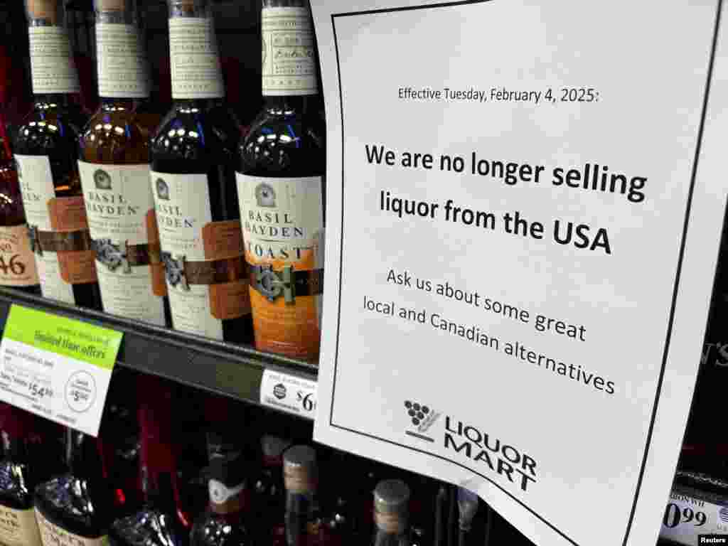 A sign notifying customers that the store will stop selling U.S. liquor effective Feb. 4, in response to U.S. President Donald Trump's imposition of tariffs on Canada, is displayed on a shelf carrying U.S. alcohol in Winnipeg, Manitoba, Canada, Feb. 2, 2025.