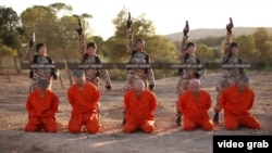 FILE - A screenshot from an Islamic State propaganda video purports to show young boys preparing to execute a group of captives.