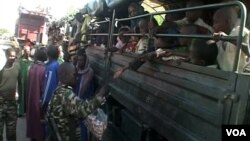 FILE - Nigerian refugees are seen on a Cameroonian military truck set to make its way out of Fotokol for Nigeria, in Fotokol, Cameroon, April 19, 2017. (M.E. Kindzeka/VOA)