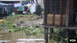 In Niger Delta cities like Warri fuel is sold in jerry cans from illegal refineires and often resold several times before it is used. (VOA/H. Murdock)
