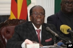 FILE - Zimbabwean President Robert Mugabe delivers a live speech to the nation, at State House, in Harare, Zimbabwe, Nov, 19, 2017.