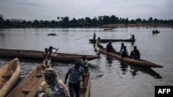FILE - Central African refugees arrive in Ndu after crossing the Mbomou River, which marks the border between the Central African Republic and the Democratic Republic of Congo, Feb. 5, 2021. 