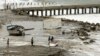 Waves pound coasts of Ecuador and Peru, closing ports, killing 2 
