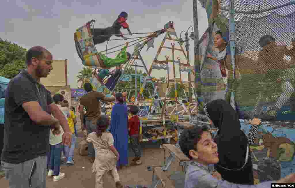 For families in Cairo, Eid includes a trip to a playground and carnival rides set up for the occasion.