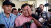 Soum Rithy, center, who lost his father and three siblings during Khmer Rouge regime, is escorted as he cries after the verdict was delivered in the trial of former Khmer Rouge head of state Khieu Samphan and former Khmer Rouge leader Nuon Chea at the co