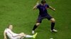 Spain's Andres Iniesta tries to reach the ball against Netherlands' Daryl Janmaat during the group B World Cup soccer match between Spain and the Netherlands at the Arena Ponte Nova in Salvador, Brazil, June 13, 2014. 
