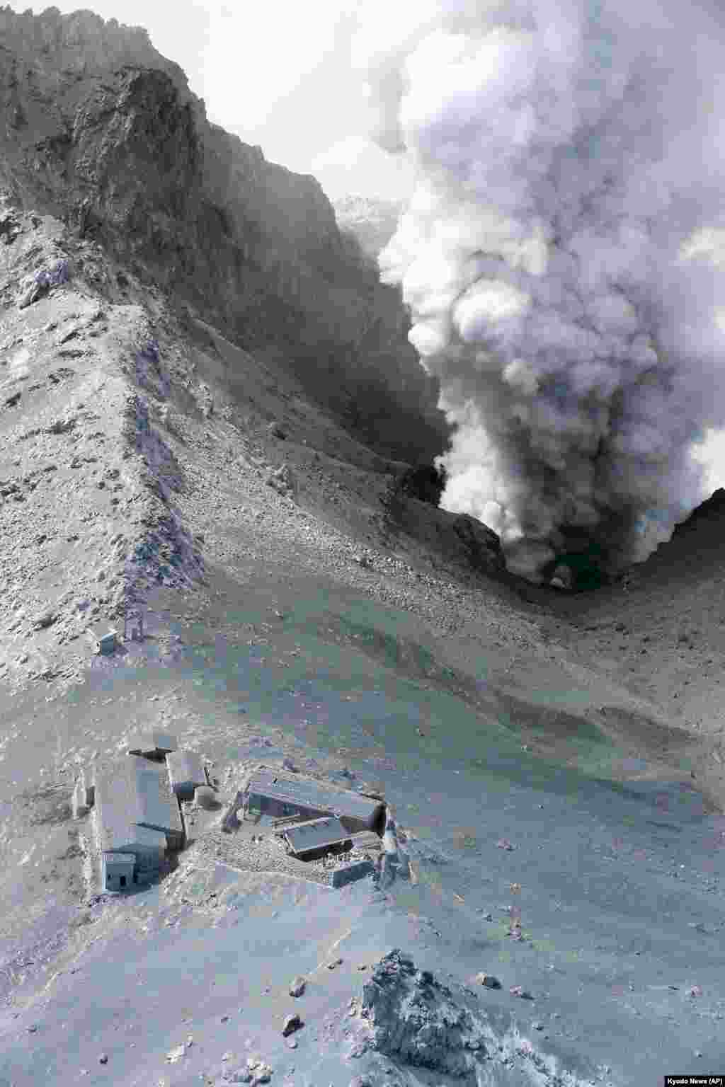 Plumes of smoke billow near a cabin on Mount Ontake in central Japan, one day after it erupted, spewing large white plumes of gas and ash high into the sky and blanketing the surrounding area in ash, Sept. 28, 2014.