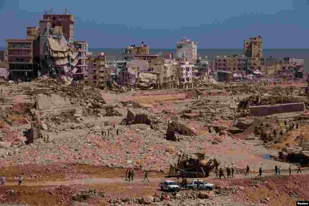 A view shows people inspecting the damaged areas, in the aftermath of the floods in Derna, Libya, Sept. 14, 2023. 