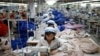 FILE - North Korean employees sew in a South Korean-owned company at the Kaesong industrial park just north of the demilitarized zone, December 2013.