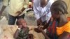 Dr. James Peter consults with Nyayub Kuol, who has brought her two-year-old son to Bentiu hospital for treatment for malaria. Unity state has seen a spike in the number of cases of malaria and Kala Azar, also called visceral leishmaniasis, especially among children. (VOA/Bonifacio Taban) 