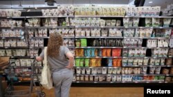 FILE PHOTO: A person shops in a supermarket as inflation affected consumer prices in Manhattan, New York City