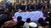 FILE - Pakistanis attend a funeral service for the victims of a bomb blast at a mosque in Parachinar, the capital of Pakistan's northwestern Kurram tribal region, Jan. 21, 2017. 