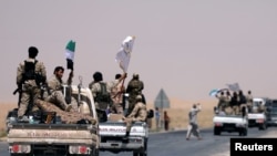 FILE - Syrian Democratic Forces (SDF) fighters head to Raqqa, Syria, June 6, 2017. 