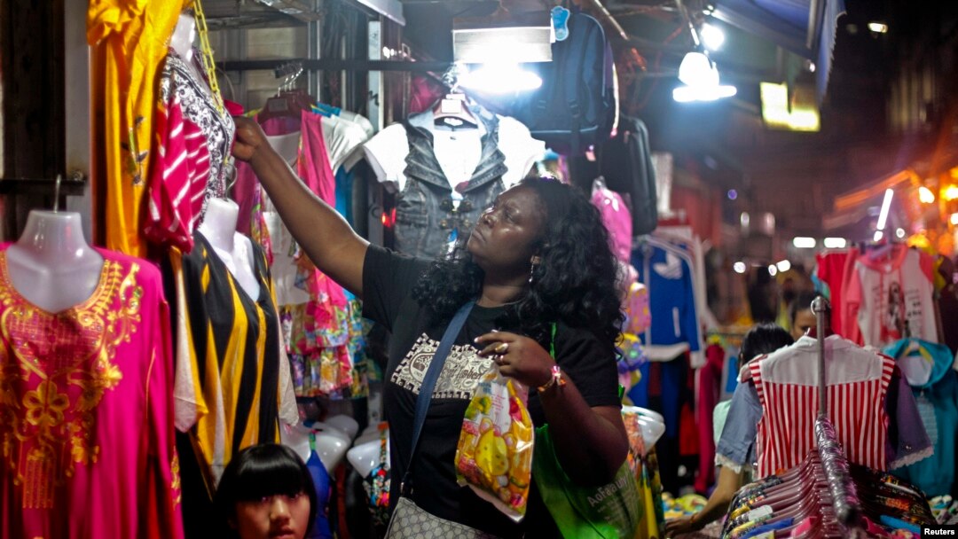 FILE - An African woman shops at a market at "African village" in Guangzhou, Guangdong province, October 25, 2014.