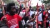 People hold wooden crosses to represent those killed in a string of attacks, during a demonstration to demand greater security on Nov. 25, 2014 in Nairobi.