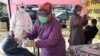 Para nakes mengambil sampel dari hidung para pemudik sebelum kembali memasuki ibu kota Jakarta, di sebuah pos pemeriksaan di Tangerang, 19 Mei 2021. (AP Photo/Tatan Syuflana)