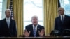 FILE - President Trump reacts to the AHCA health care bill being pulled by Congressional Republicans before a vote as he appears with Secretary of Health and Human Services Tom Price (L) and Vice President Mike Pence (R) in the Oval Office of the White House in Washington, March 24, 2017. 