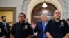 Former U.S. President Donald Trump talks to members of the media outside the court room at the New York State Supreme Court on the first day of his civil fraud trial, in New York City on Oct. 2, 2023.
