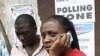 An election officer in Nigeria's commercial capital, Lagos, makes a phone call after the postponement of parliamentary elections, April 2, 2011