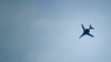 FILE - A U.S.-led coalition aircraft flies over Kobanii, as seen near the Mursitpinar border crossing on the Turkish-Syrian border in the southeastern town of Suruc in Sanliurfa province.