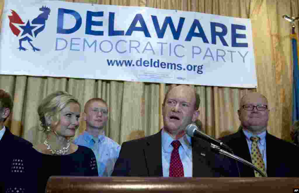 In Delaware, Democrat Chris Coons wins reelection and speaks to supporters at an election night party in Newark. He celebrates with wife Annie, left, and family, Nov. 4, 2014.