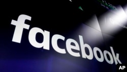 In this March 29, 2018 file photo shows the logo for Facebook at the Nasdaq MarketSite, in New York's Times Square. Facebook on Friday, Feb. 14, 2020.