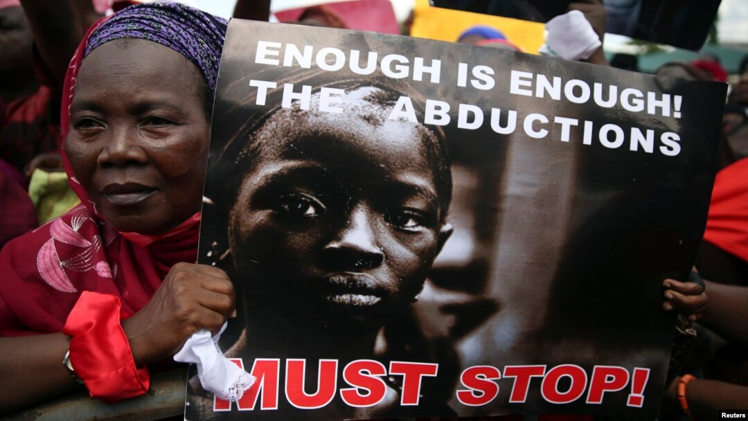 A woman holds a sign during a protest demanding the release of abducted secondary school girls from the remote village of Chibok, in Lagos, May 5, 2014. 