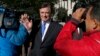 Paul Manafort makes his way through television cameras as he walks from Federal District Court in Washington, Oct. 30, 2017. 
