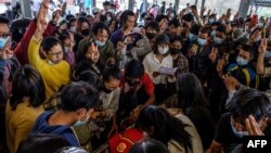 Mourners make the three-finger salute as they attend the funeral of a protester, who died amid a crackdown by security forces on demonstrations against the military coup, in Taunggyi in Myanmar's Shan state on March 29, 2021.