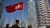 FILE - North Korean soldiers carry the Korean People's Army flag as they walk past residential buildings along Ryomyong street, in Pyongyang, North Korea, April 13, 2017.