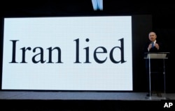 FILE - Israeli Prime Minister Benjamin Netanyahu presents material on Iranian nuclear weapons development during a press conference in Tel Aviv, April 30, 2018.