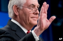 FILE - Secretary of State Rex Tillerson waves goodbye at the State Department in Washington, March 13, 2018, after his firing earlier in the day. President Donald Trump said he would nominate CIA Director Mike Pompeo as the top U.S. diplomat.