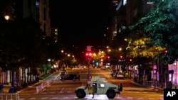 A military Humvee blocks an intersection along K Street in downtown Washington as demonstrators protest the death of George Floyd, Monday, June 1, 2020, in Washington.