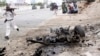 A Somali soldier runs to fight near the wreckage of a car bomb during an attack on Somalia's parliament, Saturday, May 24, 2014. 