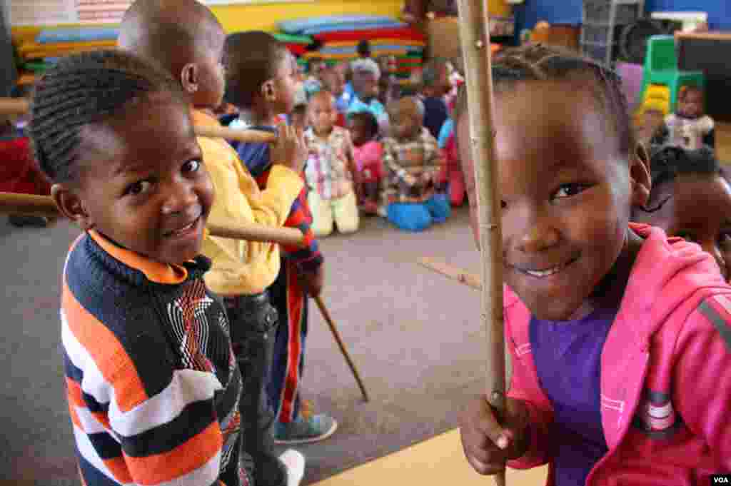 Children at Soweto's Mapetla Care Center are showered with love by their teachers. Many were left behind when their parents died in South Africa epidemics. (Photo by Darren Taylor)