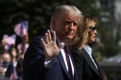 FILE - U.S. President Donald Trump waves to reporters as he departs with first lady Melania Trump to participate in his first presidential debate with Democratic presidential nominee Joe Biden in Cleveland, Ohio, Sept. 29, 2020.