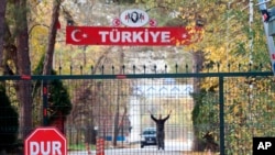 FILE - A man who is identified by Turkish news reports as a U.S. citizen is seen in the heavily militarized no-man's land between Greece and Turkey, near Pazarkule border gate, Edirne, Turkey, Nov. 11, 2019.