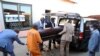 South Africa undertakers load a casket on a hearse