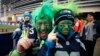 Seattle Seahawks fans Todd Gibson and his son Karsten pose outside the stadium before the start of the NFL Super Bowl XLVIII football game in East Rutherford, New Jersey, Feb. 2, 2014. 