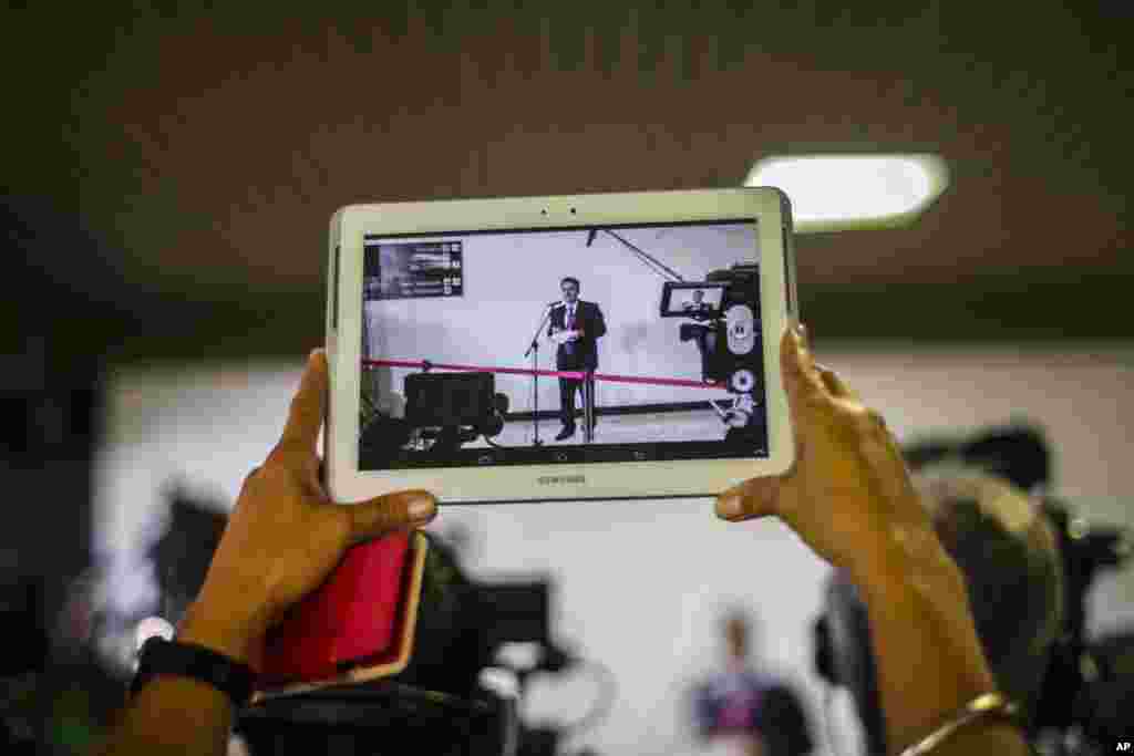 A journalist records a video of Gustavo Machin, Cuba’s deputy chief of North American affairs, during the second day of talks between Cuban and U.S. officials, in Havana, Jan. 22, 2015.
