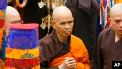FILE - Vietnamese Zen master Thich Nhat Hanh, center, arrives for a great chanting ceremony at Vinh Nghiem Pagoda in Ho Chi Minh City, Vietnam, March 16, 2007.