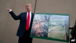 FILE - President Donald Trump talks with reporters as he gets a briefing on border wall prototypes, in San Diego, California March 13, 2018.