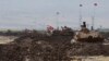 Turkish and Iraqi soldiers sit on Turkish tanks during the exercises in Silopi, near the Habur border gate with Iraq, southeastern Turkey, Sept. 26, 2017.